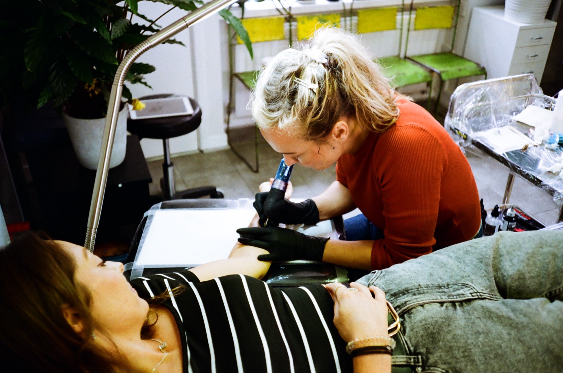 Gosia tattooing fine-line botanical work in her Bristol studio