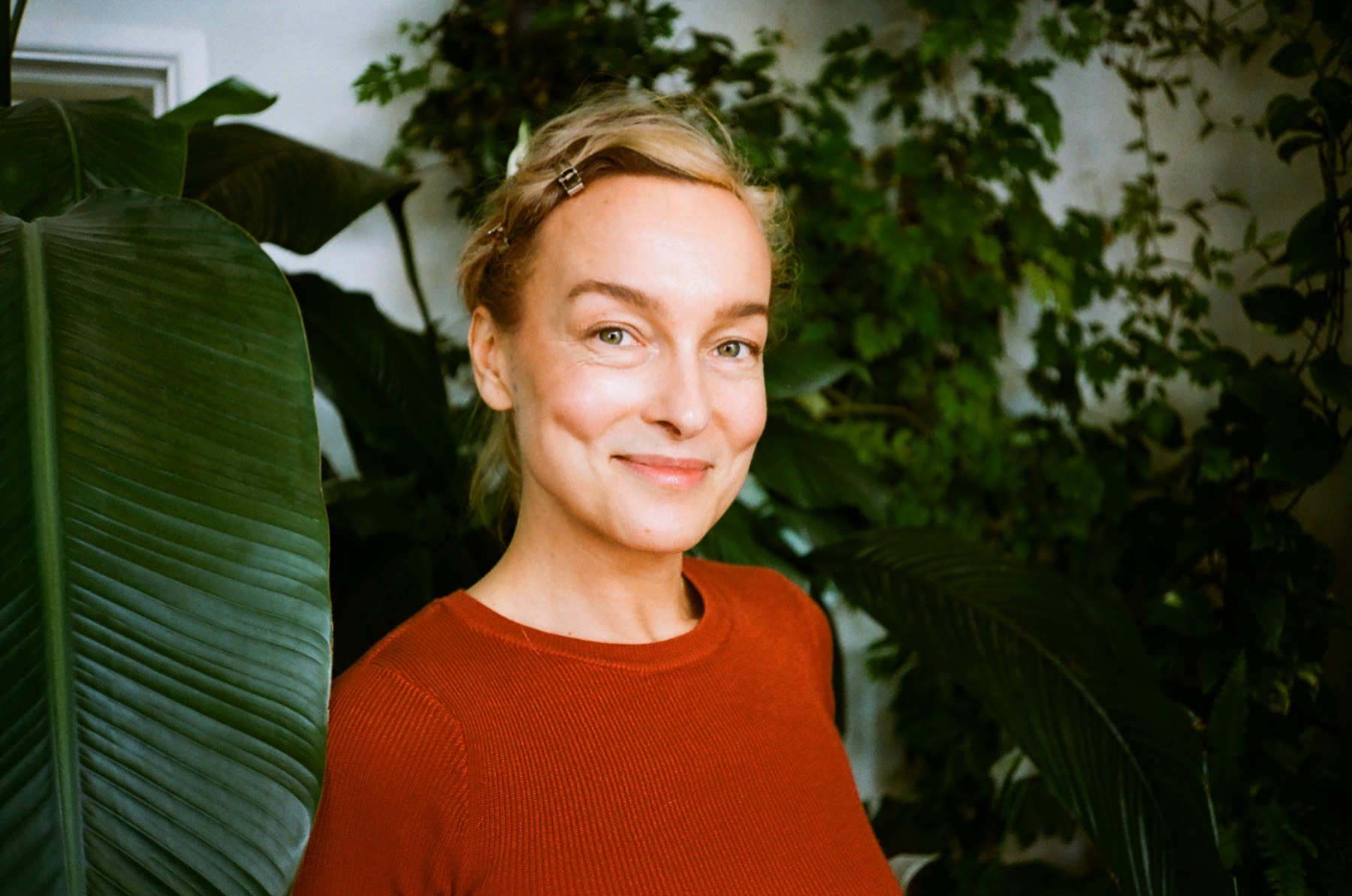 Portrait of Gosia, botanical tattoo artist, among the plants in her Bristol studio