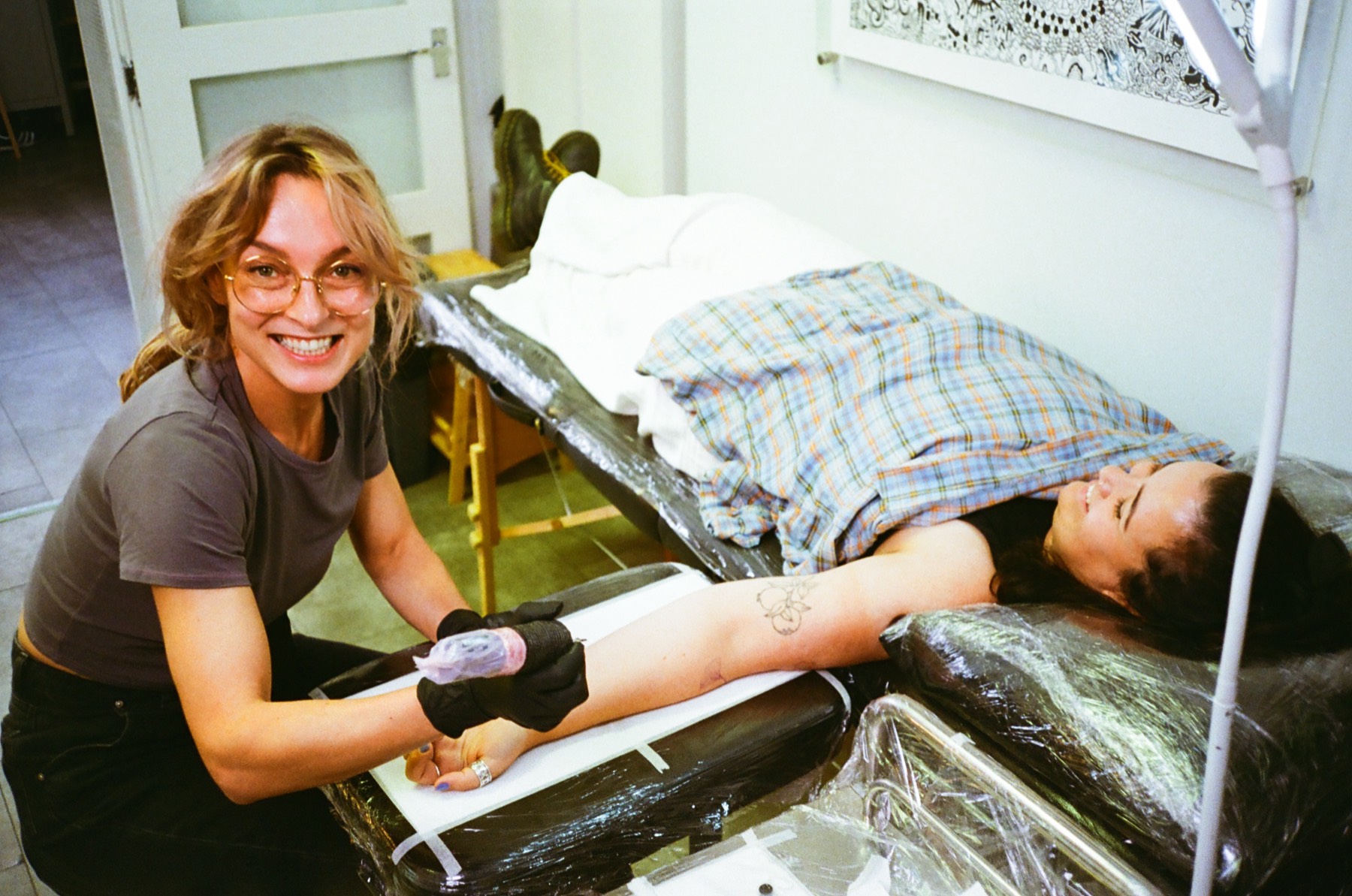 Gosia tattooing a smiling client in her Bristol studio