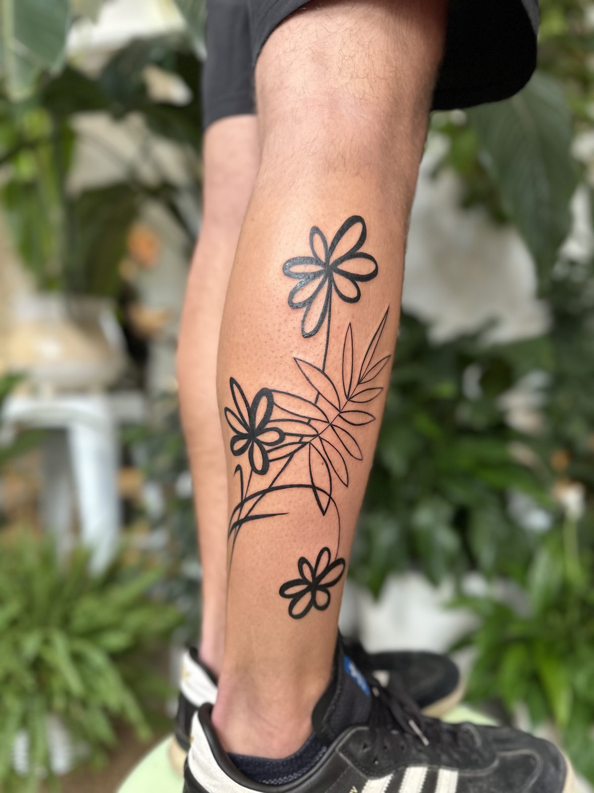 Bold illustrative floral calf tattoo, by Gosia, Bristol