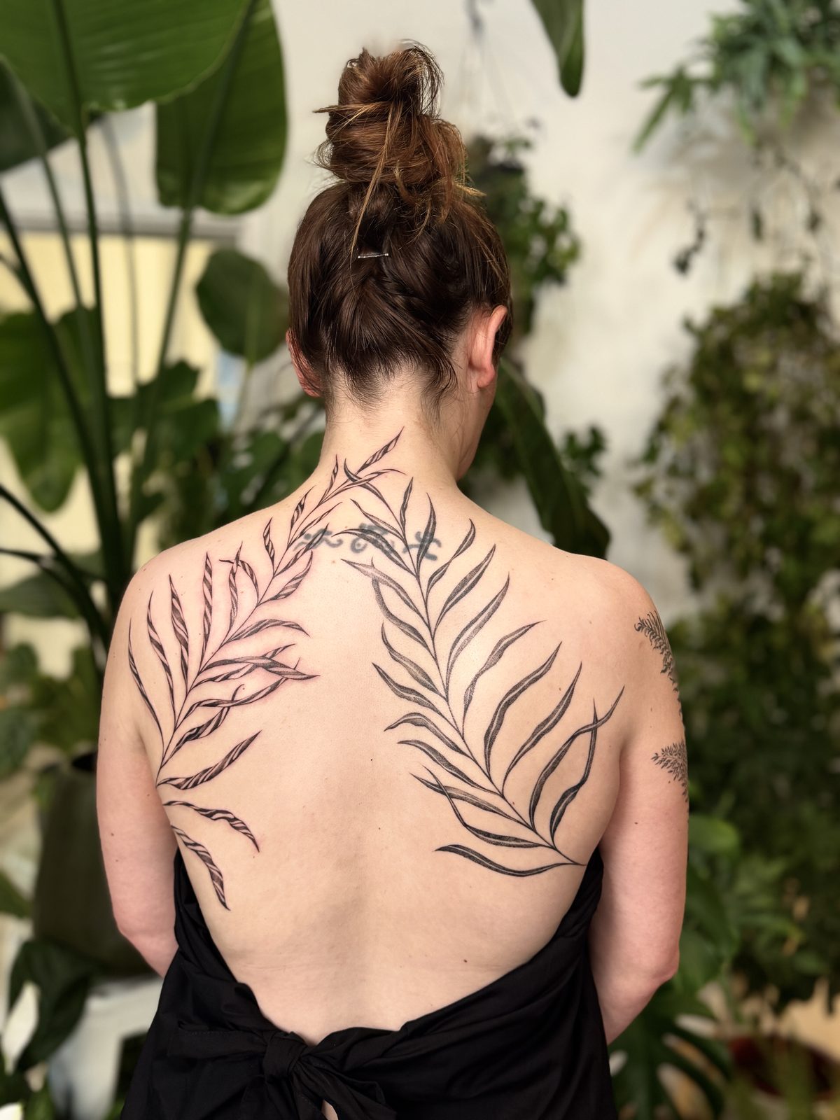 Botanical fern leaf back tattoo, fine line, by Gosia, Bristol